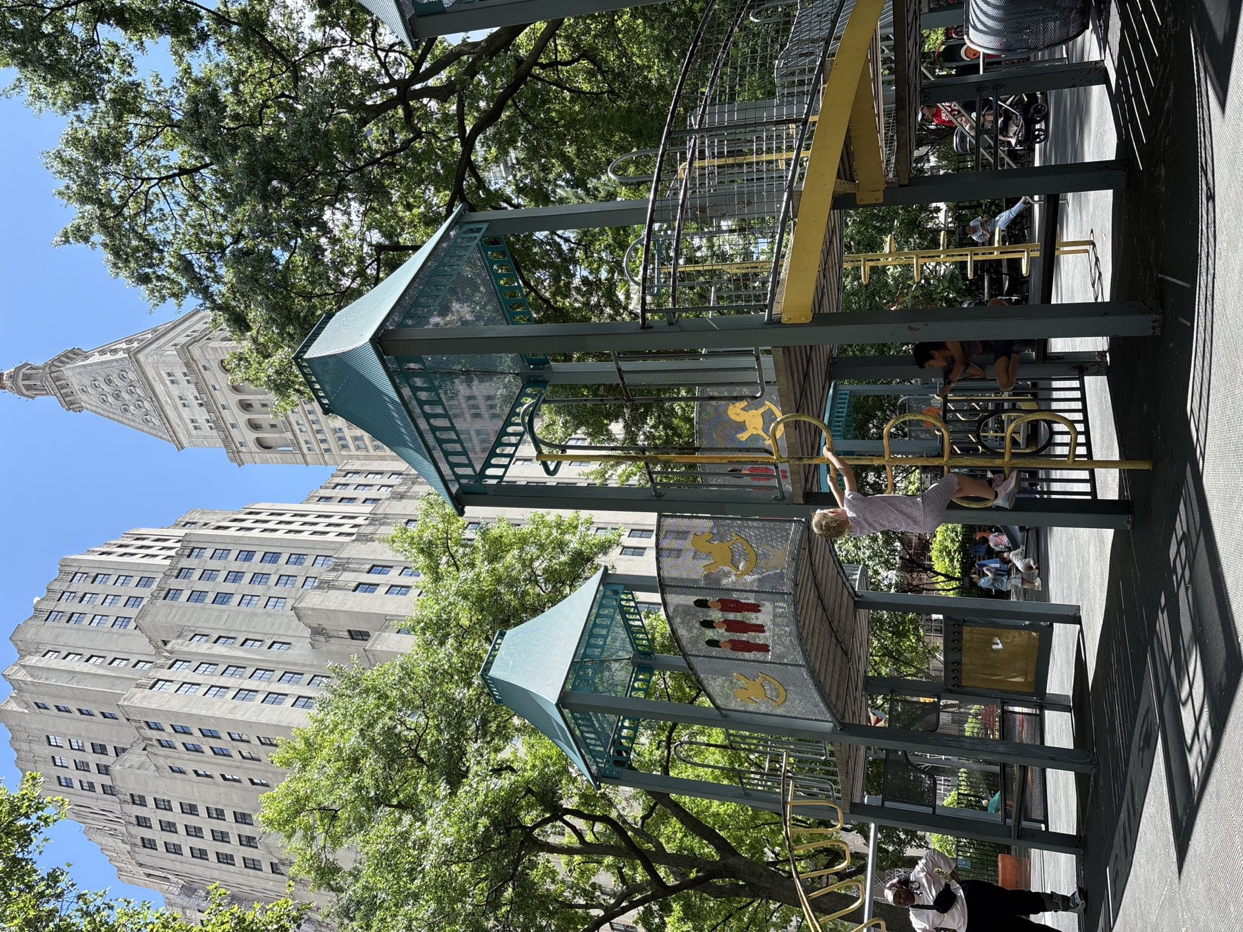 A playground packed into the city grid, with the Flatiron-area skyline rising directly behind it